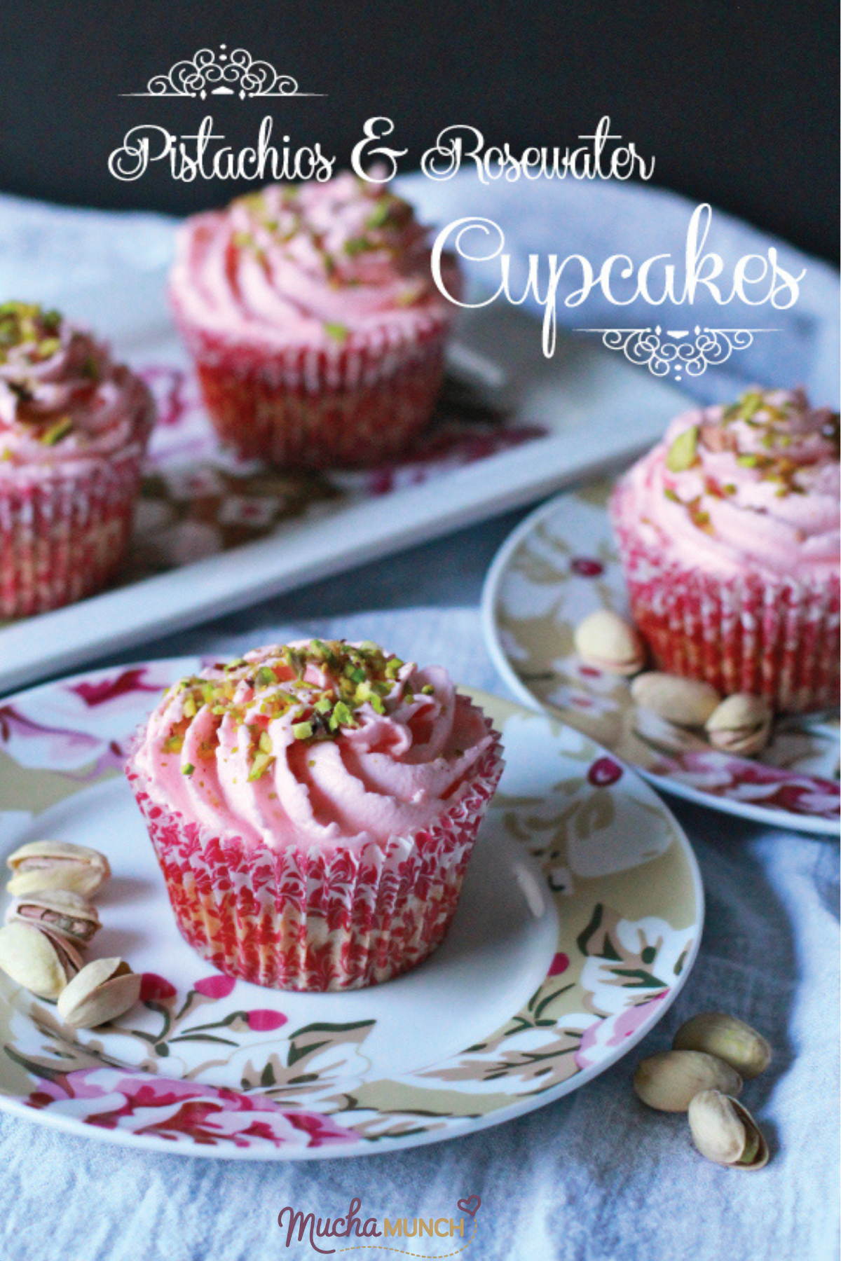 Rosewater and Pistachio Cupcakes with pink frosting, topped with crushed pistachios in floral cupcake liners.