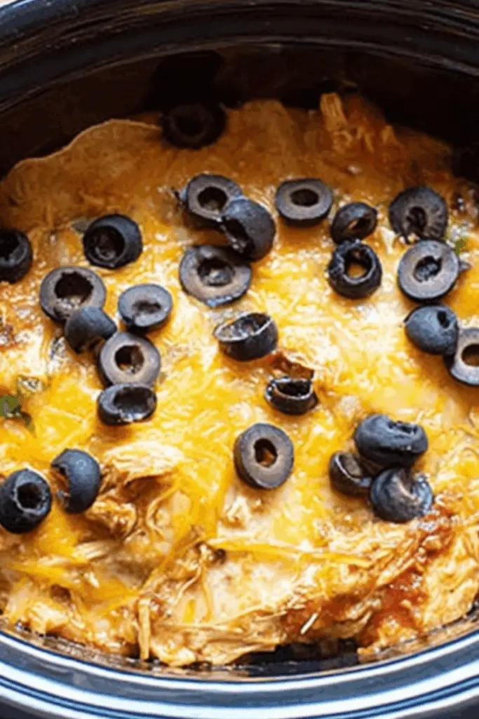 Crockpot Chicken Enchilada Casserole recipe with melted cheese and black beans