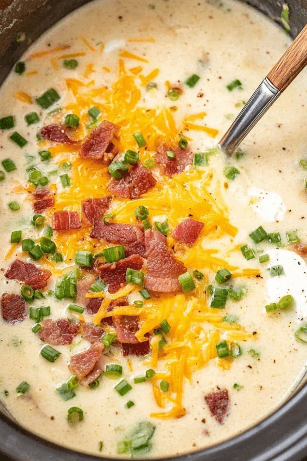 Crockpot Potato Soup served in a bowl with cheese and bacon