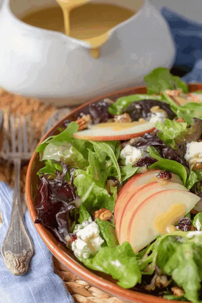 Fall Salad with Maple Vinaigrette featuring apples, blue cheese, and cranberries