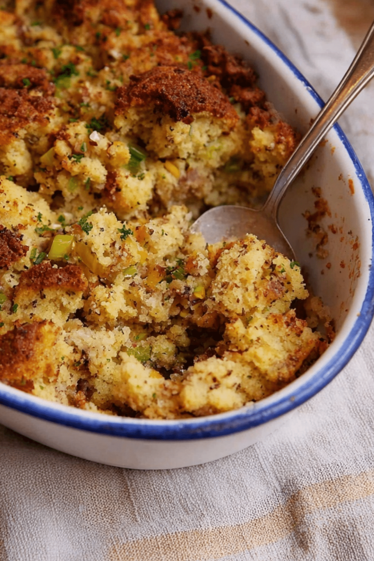 Old-Fashioned Cornbread Dressing served with herbs and chicken broth