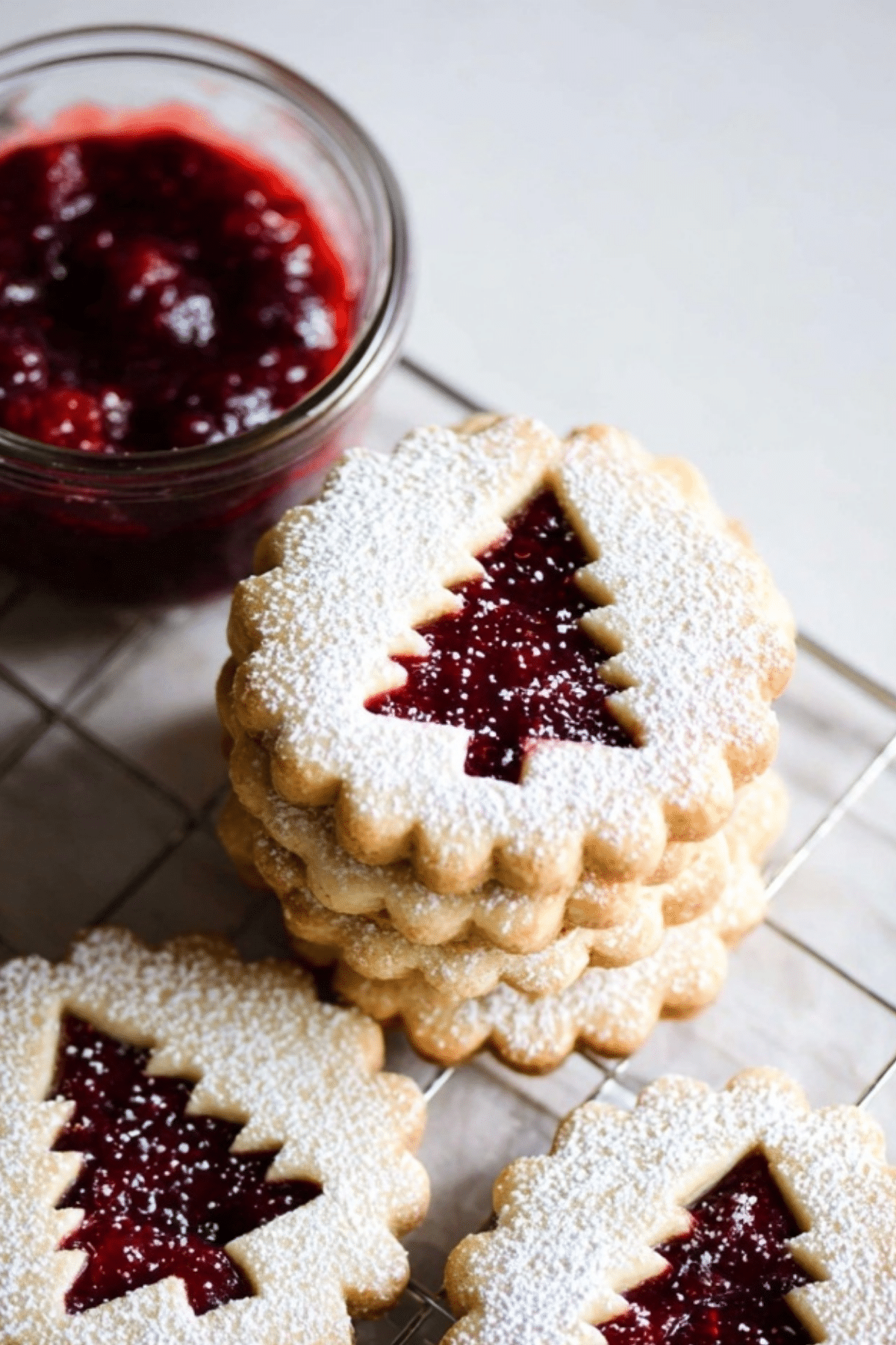 Raspberry Linzer Cookies with raspberry jam filling and festive cutout