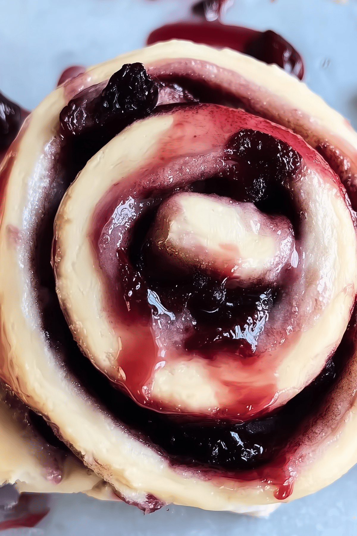 freshly baked cherry cinnamon rolls with cream cheese frosting