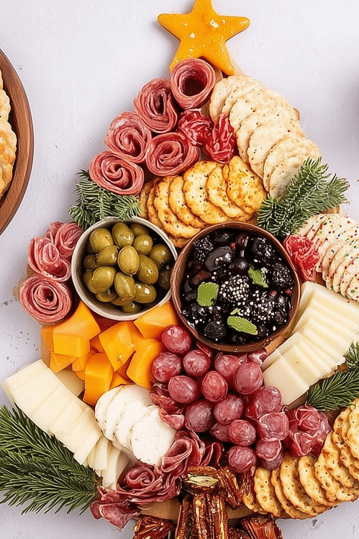 Festive Christmas Tree Charcuterie Board with meats, cheeses, and fruit
