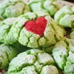 Festive Crinkle Cookies with red hearts on top, dusted in sugar