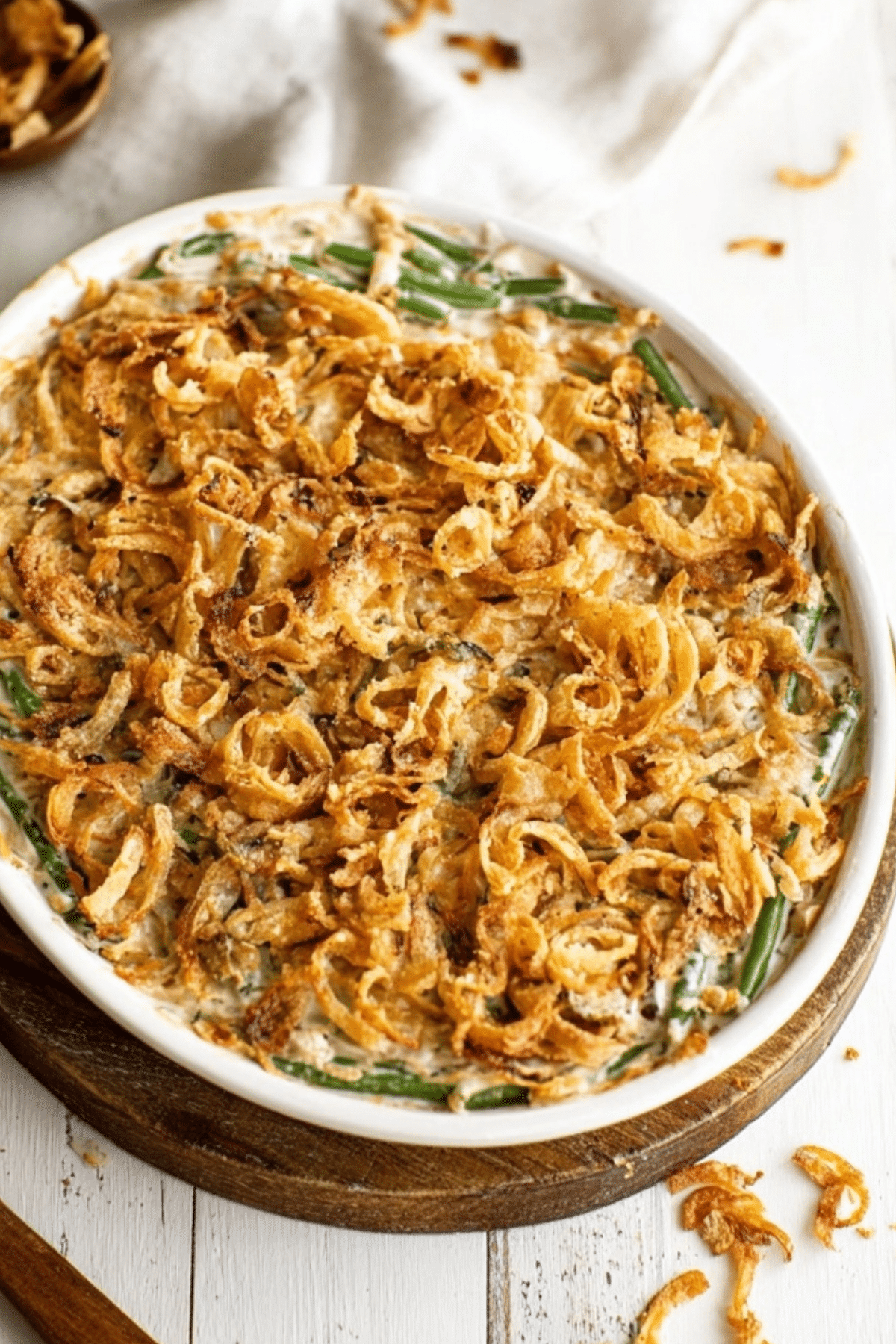 Green Bean Casserole topped with crispy fried onions in a baking dish