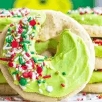 Grinch Crumbl Christmas Sugar Cookies with green frosting and red heart