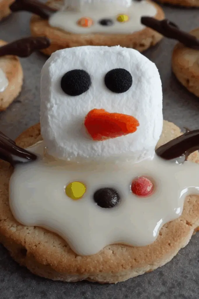 melted snowman biscuits decorated with marshmallows and icing