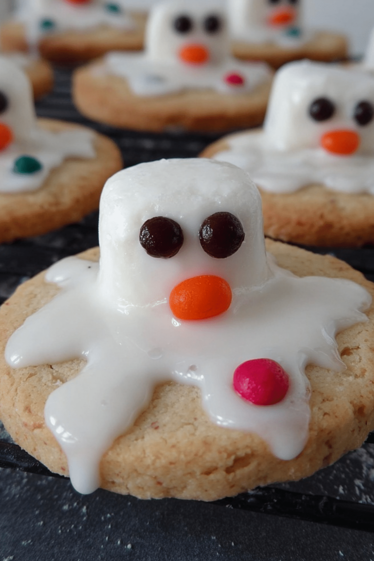 melted snowman biscuits decorated with marshmallows and icing
