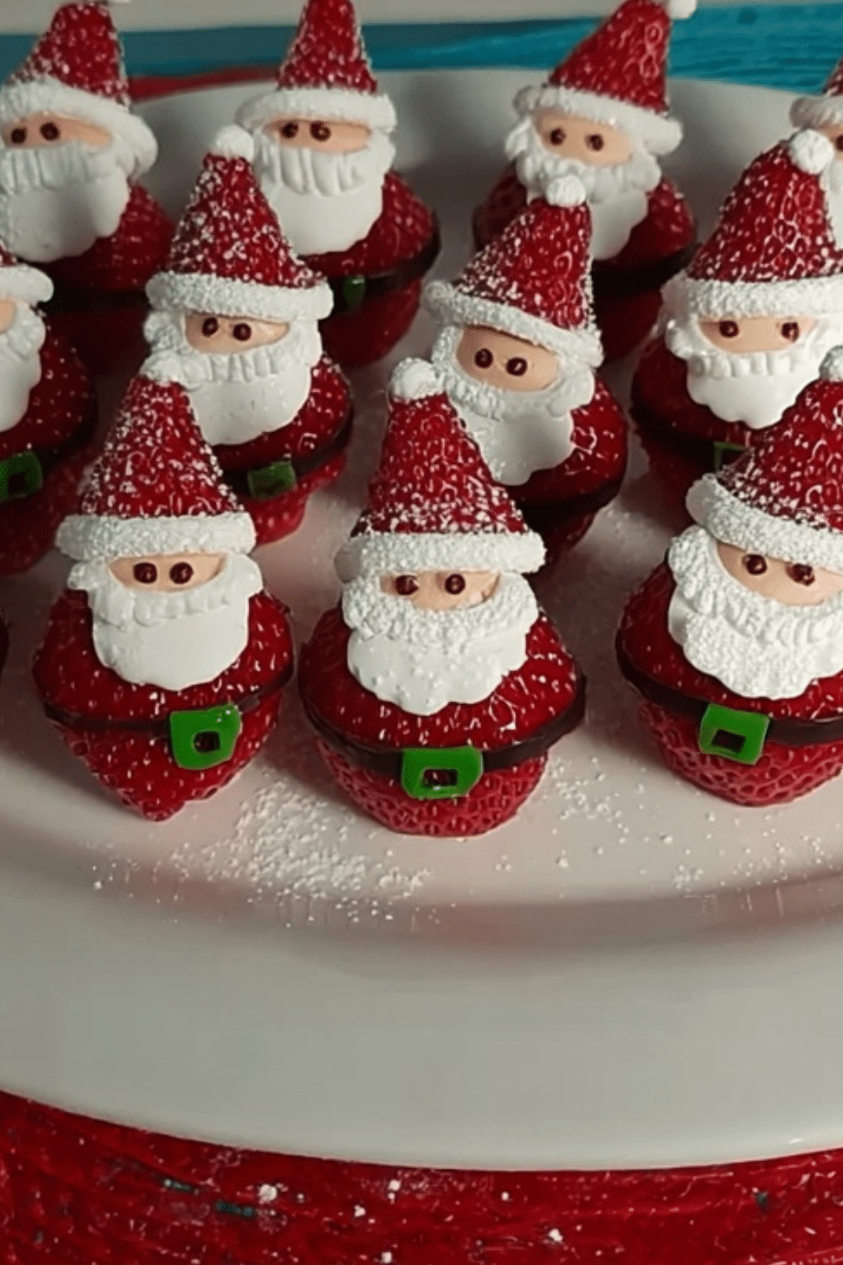 Mini Strawberry Santas made with whipped cream and sprinkles