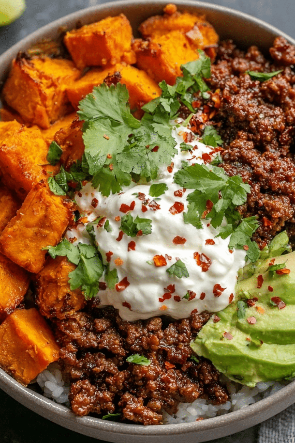 Sweet Potato Taco Bowl with smoky roasted sweet potatoes, taco beef, pico, and guacamole