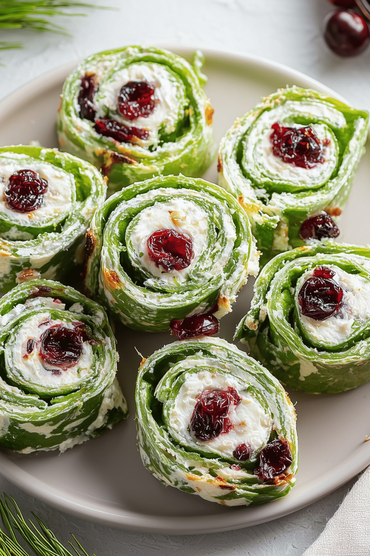 Tasty Christmas Cranberry Pinwheels served on a holiday platter