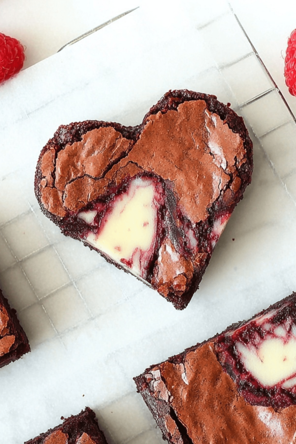 Heart-shaped brownies with cheesecake topping and raspberry swirl