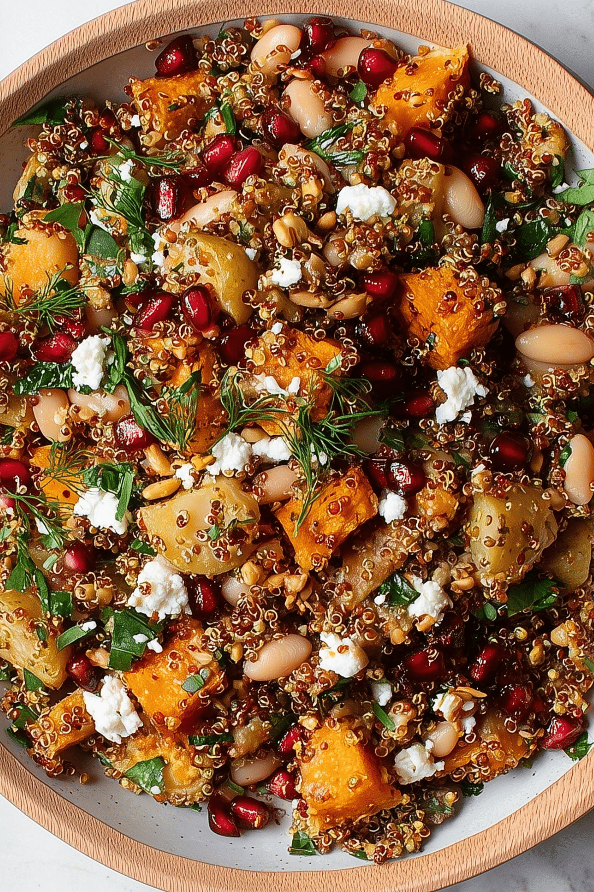 Potato White Bean Salad With Crispy Quinoa in bowl with harissa dressing