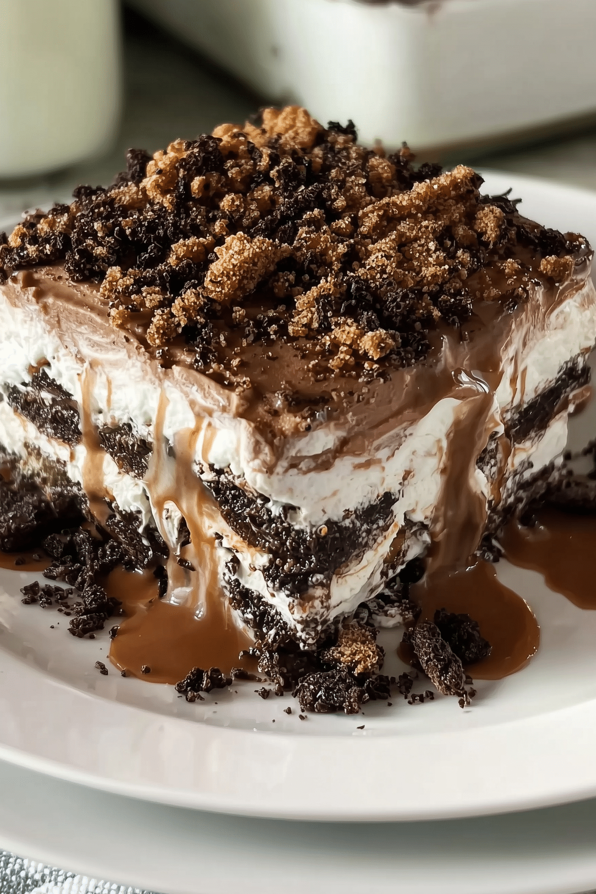 Chocolate lasagna layered dessert with Oreo crust and creamy chocolate filling