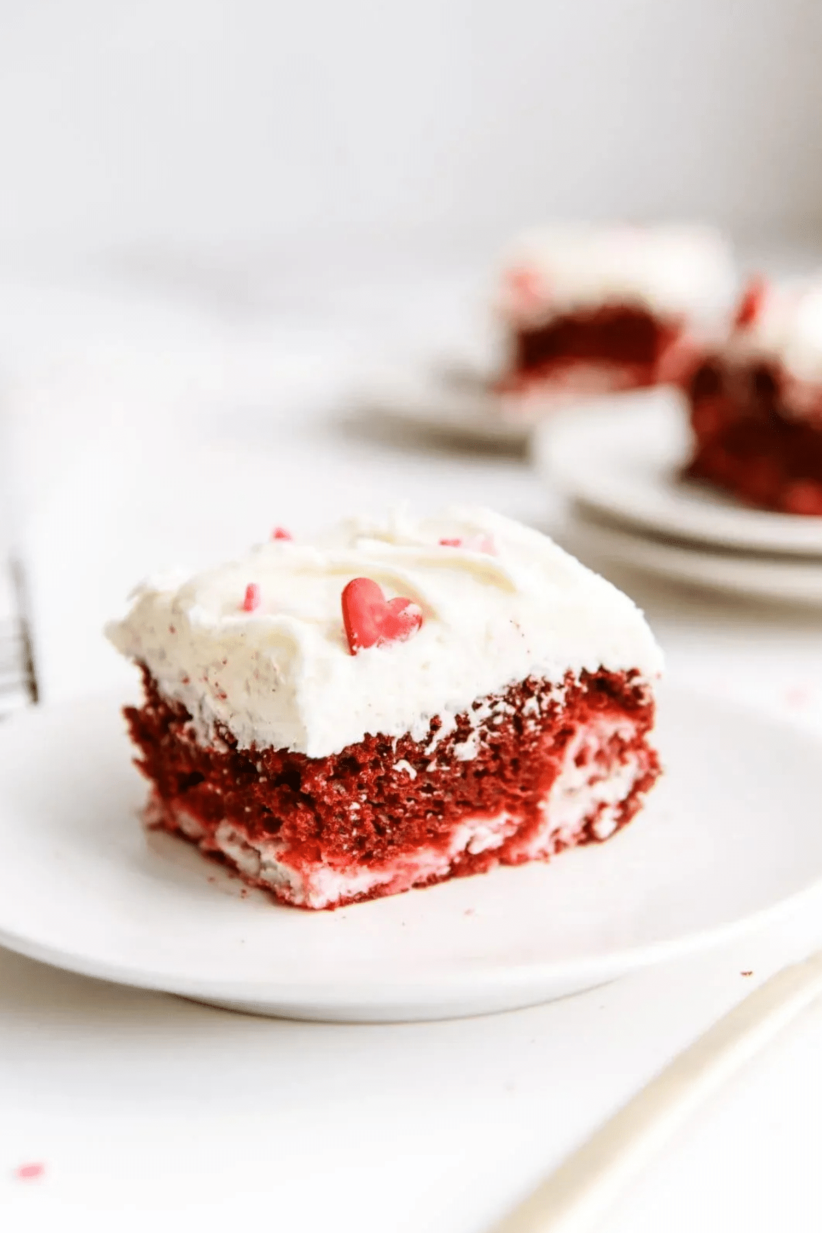 Red Velvet Cheesecake Swirl Cake topped with cream cheese frosting