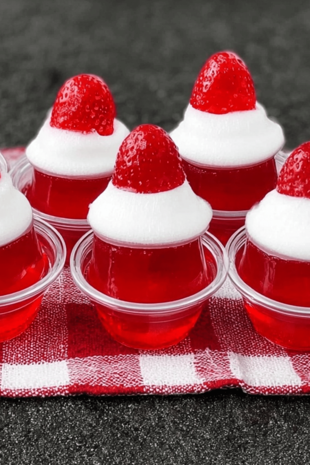Santa Hat Jello Shots with whipped cream and strawberry topping