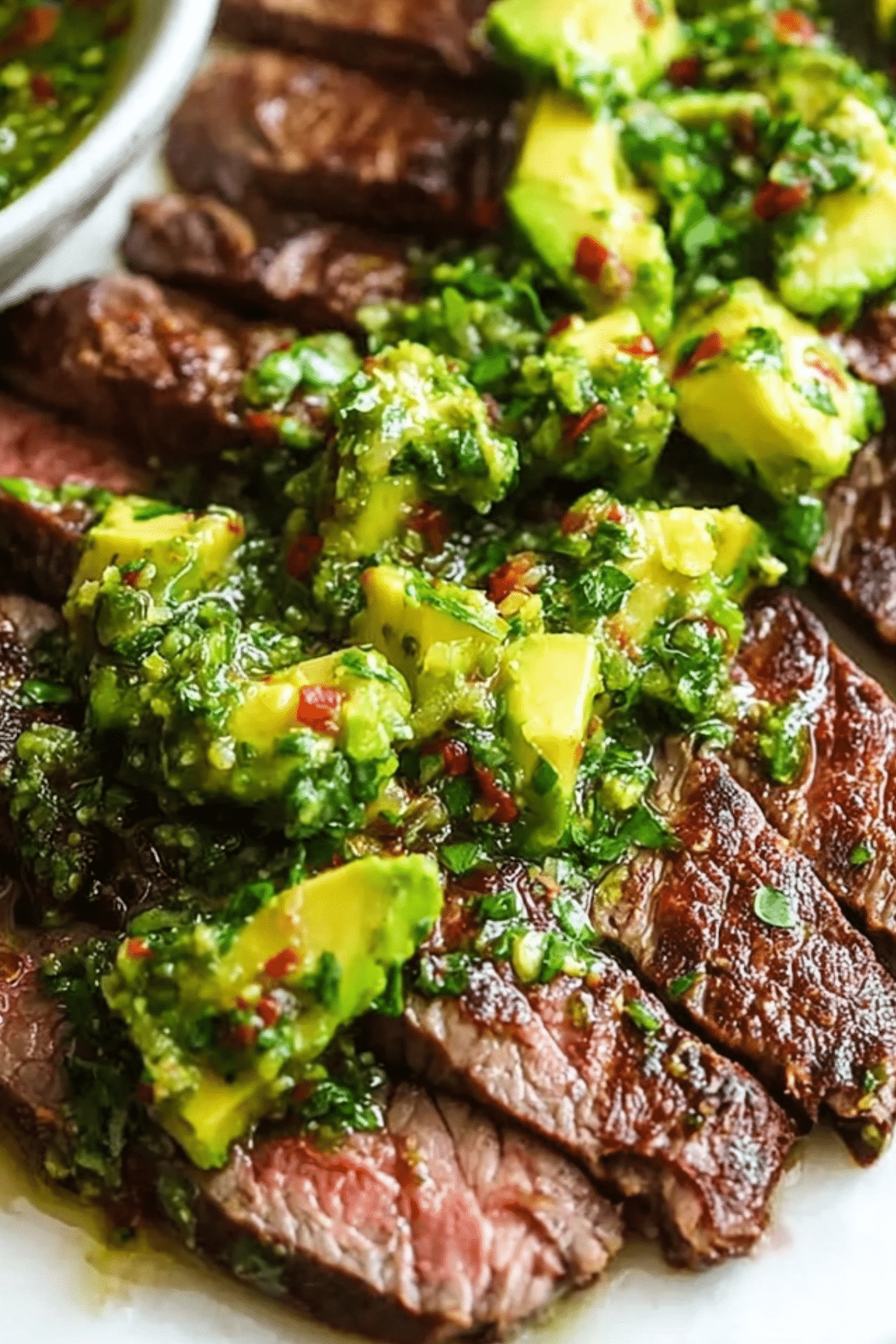 Skirt Steak with Avocado Chimichurri served with fresh herbs and sauce