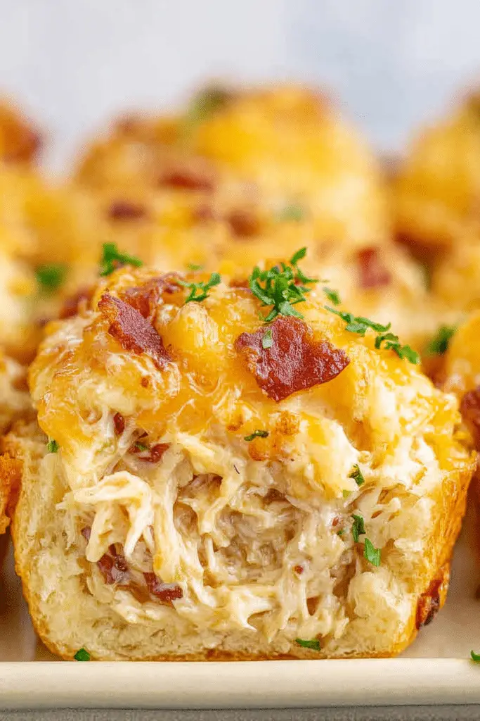 Crack Chicken Biscuits baked in muffin tin with cheddar, bacon, and ranch chicken filling