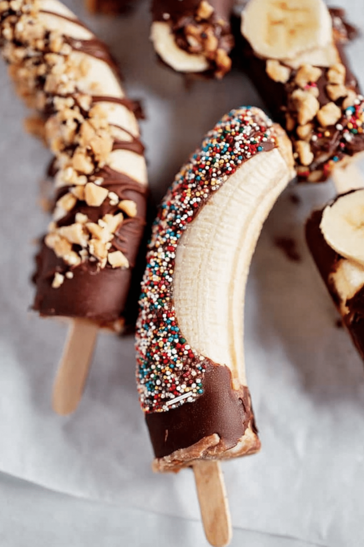 Frozen Chocolate Banana Pops dipped in chocolate with colorful toppings