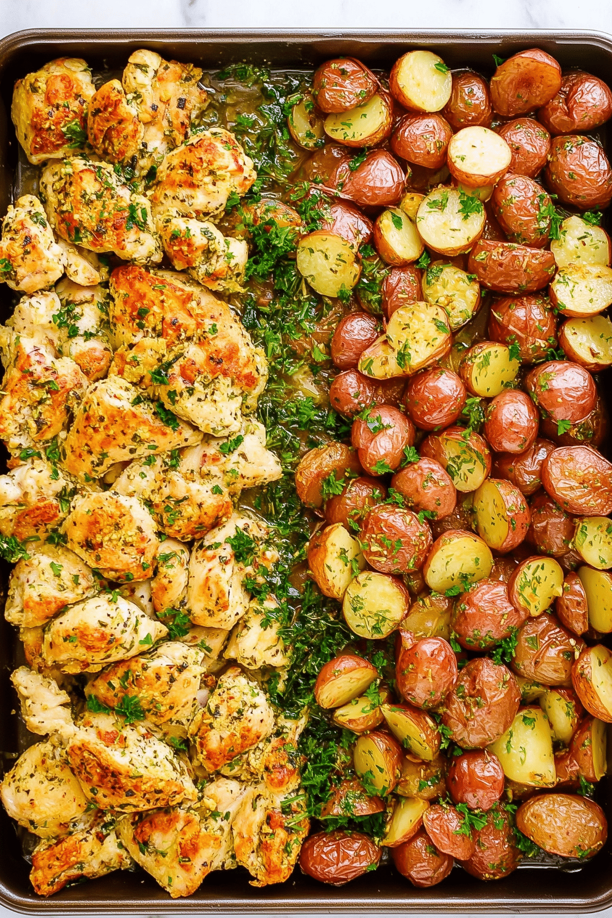 Garlic Parmesan Chicken and Potatoes baked on a sheet pan