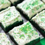 Green Velvet Brownies with Cream Cheese Frosting topped with creamy frosting and festive sprinkles