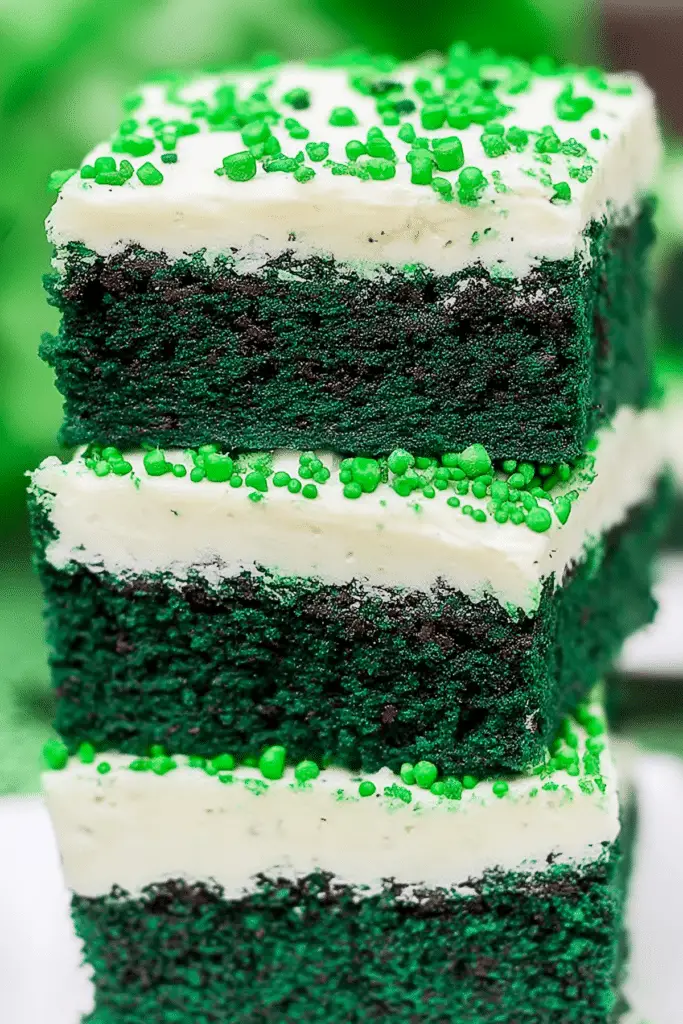 Green Velvet Brownies with Cream Cheese Frosting topped with creamy frosting and festive sprinkles