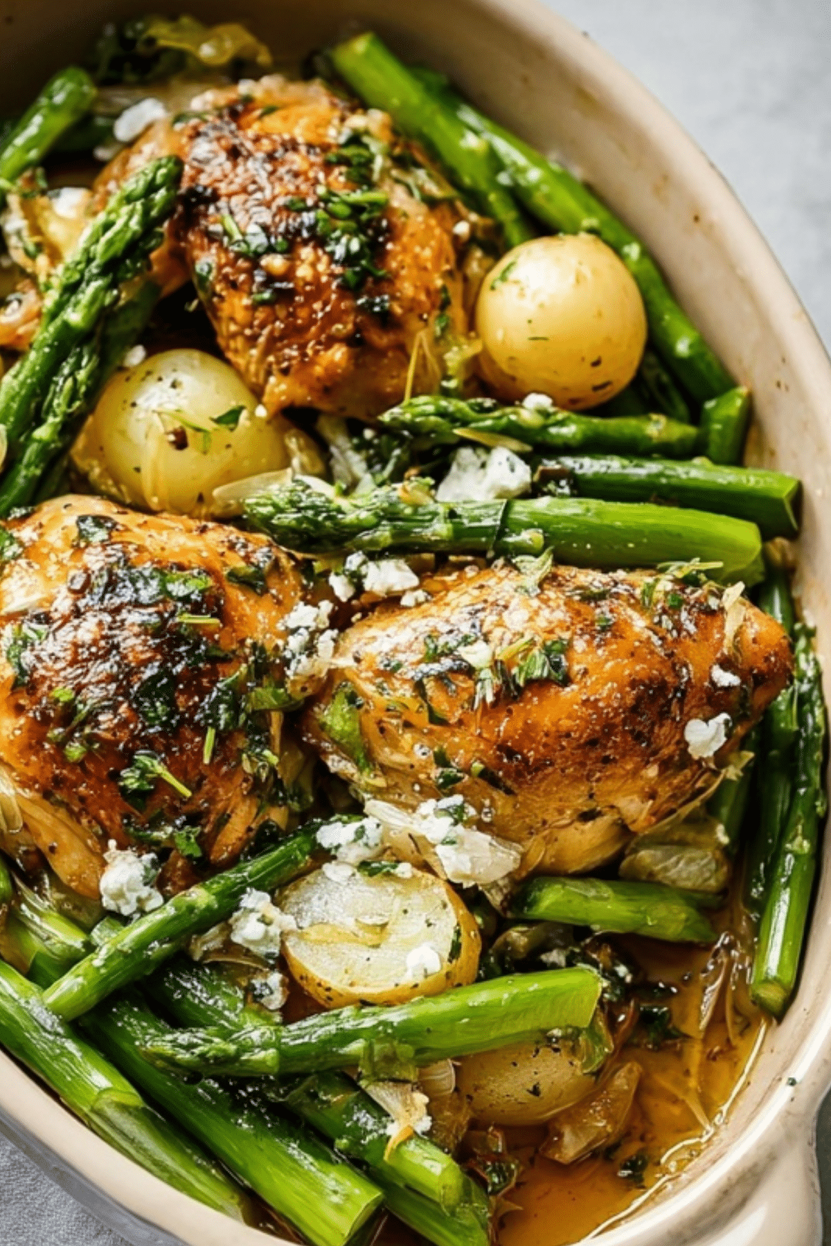 Herb Roasted Chicken With Spring Veggies served on a sheet pan