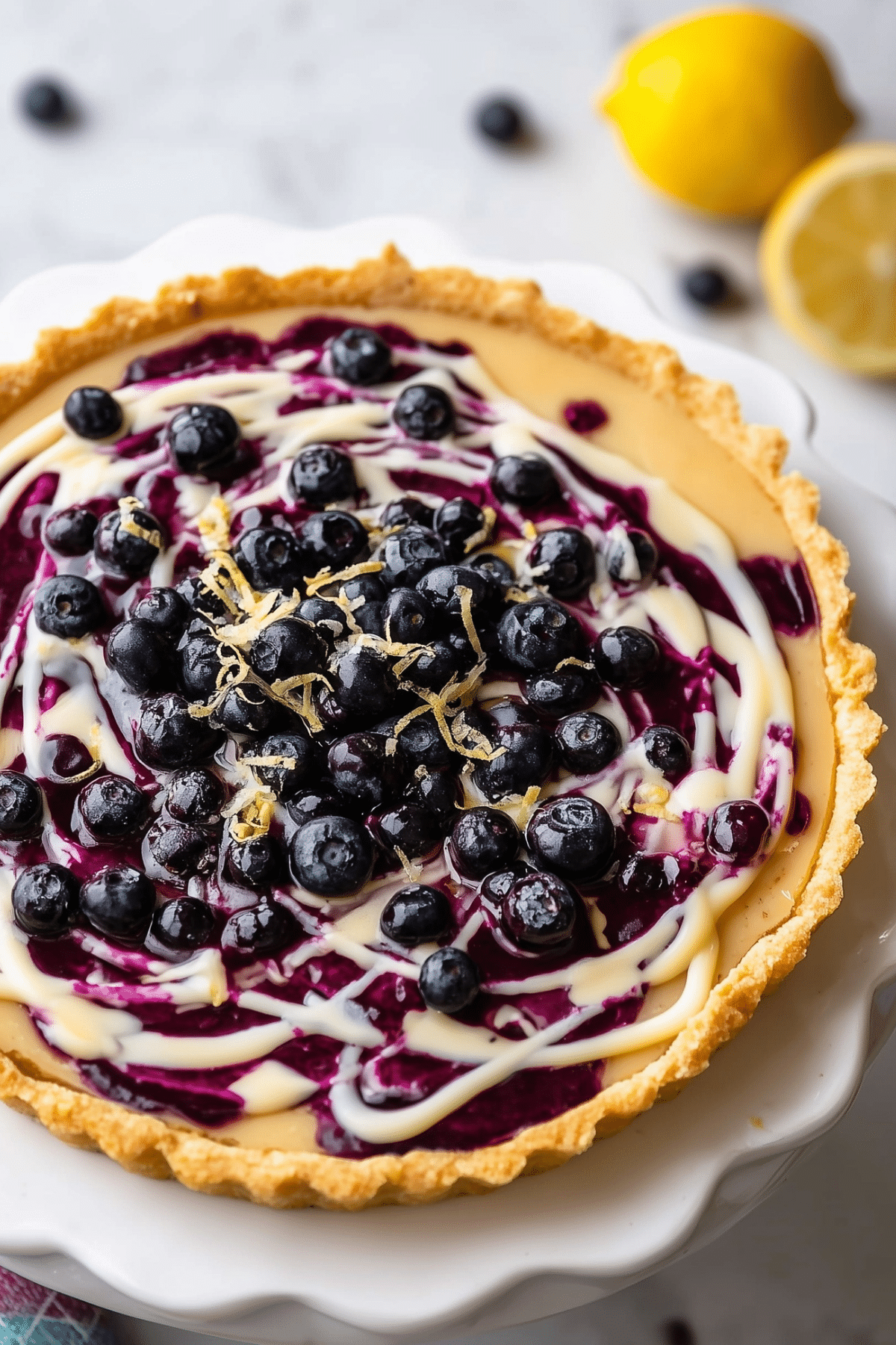 Lemon Blueberry Tart with creamy lemon filling and blueberry swirls