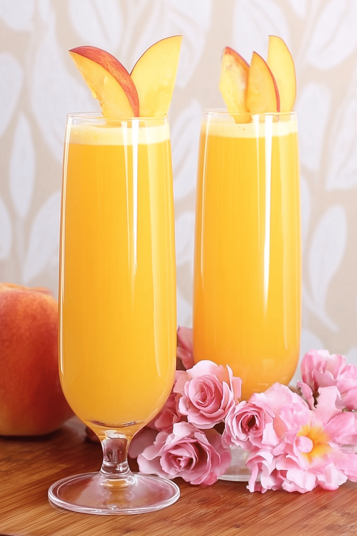 Peach Bellini Mocktail served in a champagne flute with fresh peach garnish