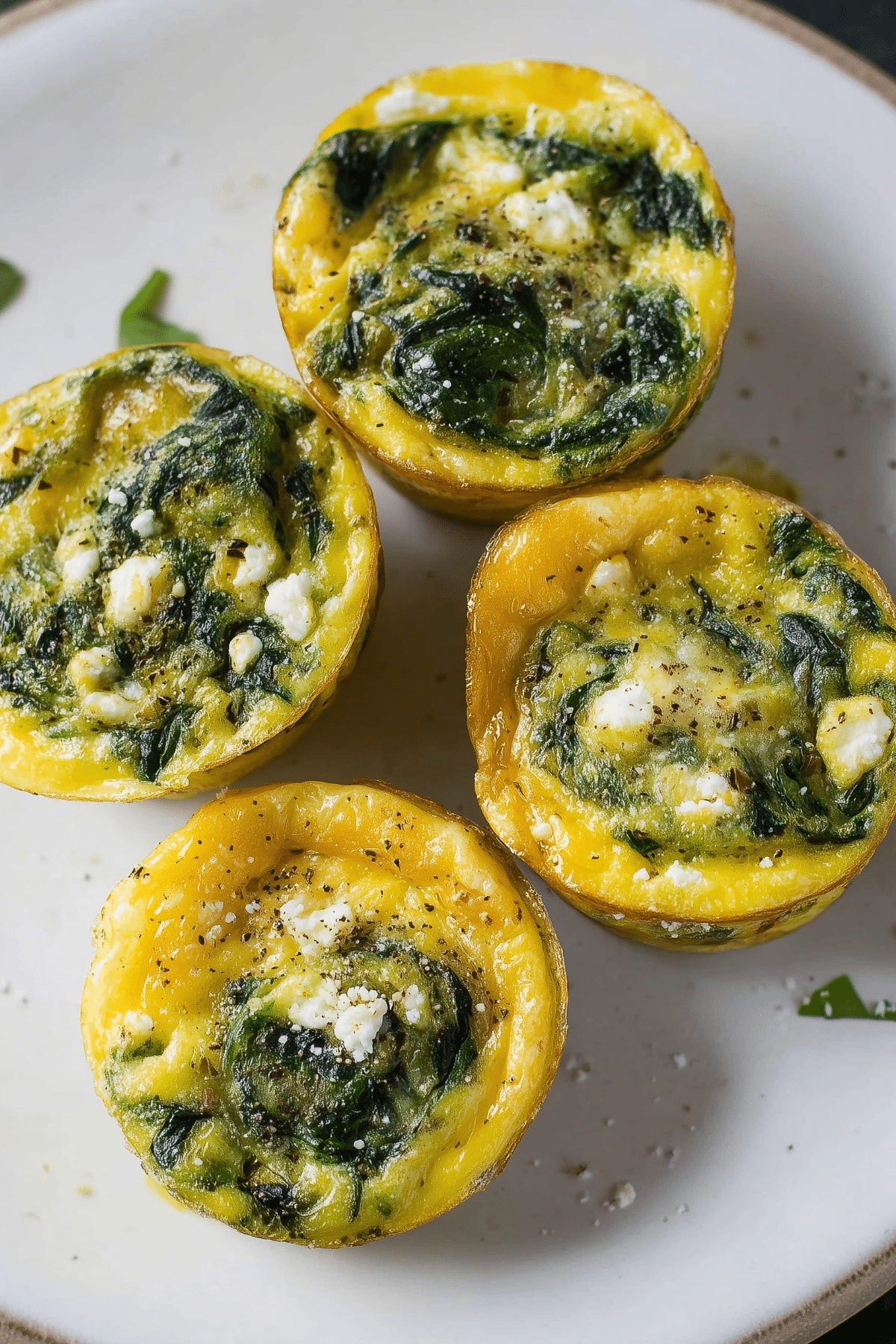 Spinach Egg Muffins baked with feta cheese in a muffin tin