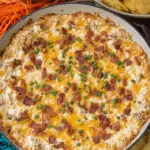 Warm Crack Chicken Dip baked with cheddar, bacon, and ranch seasoning