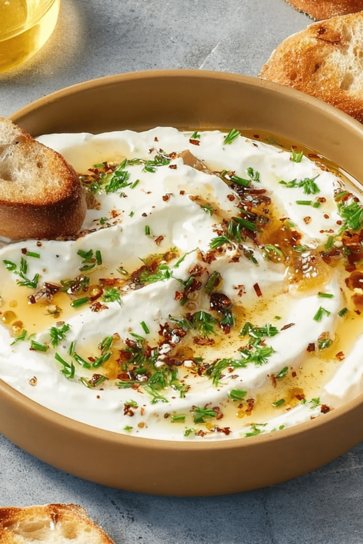 Whipped Ricotta Dip with Hot Honey served with crostini and fresh herbs