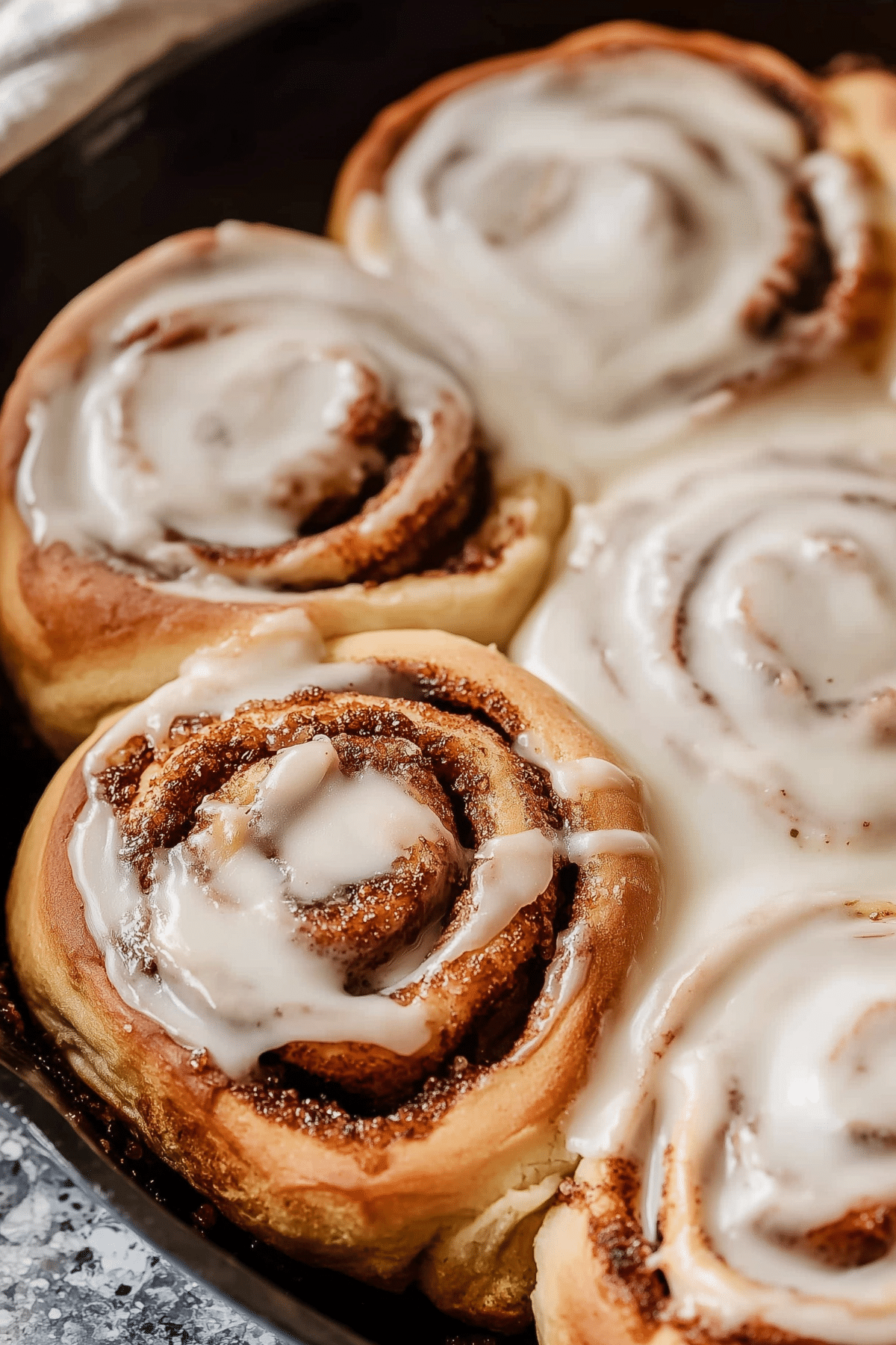 Sourdough Cinnamon Rolls with vanilla glaze in a baking pan