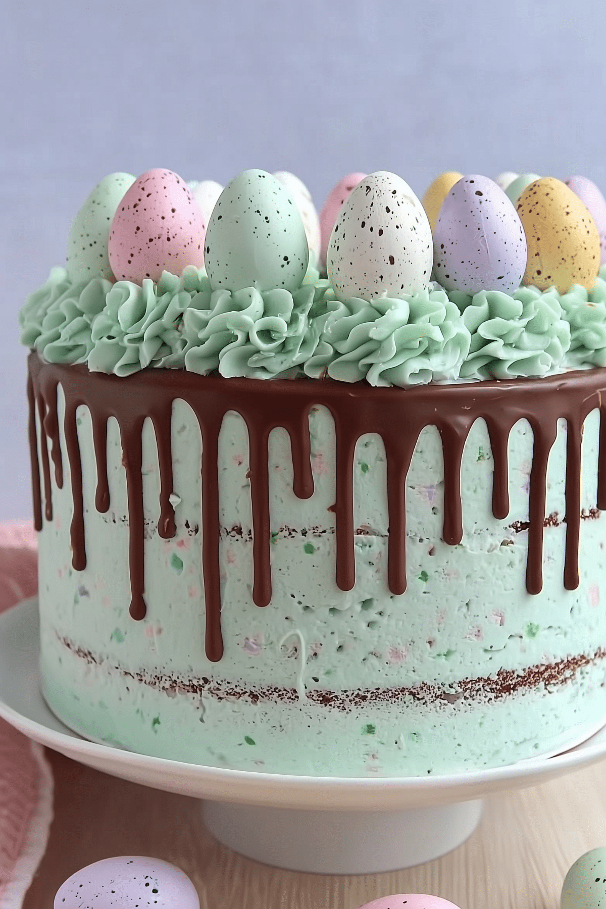 Easter Speckled Egg Drip Cake with colorful ganache and mini eggs
