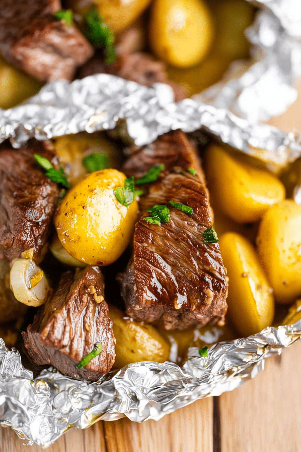 Garlic Butter Steak and Potato Foil Packets served hot with herbs