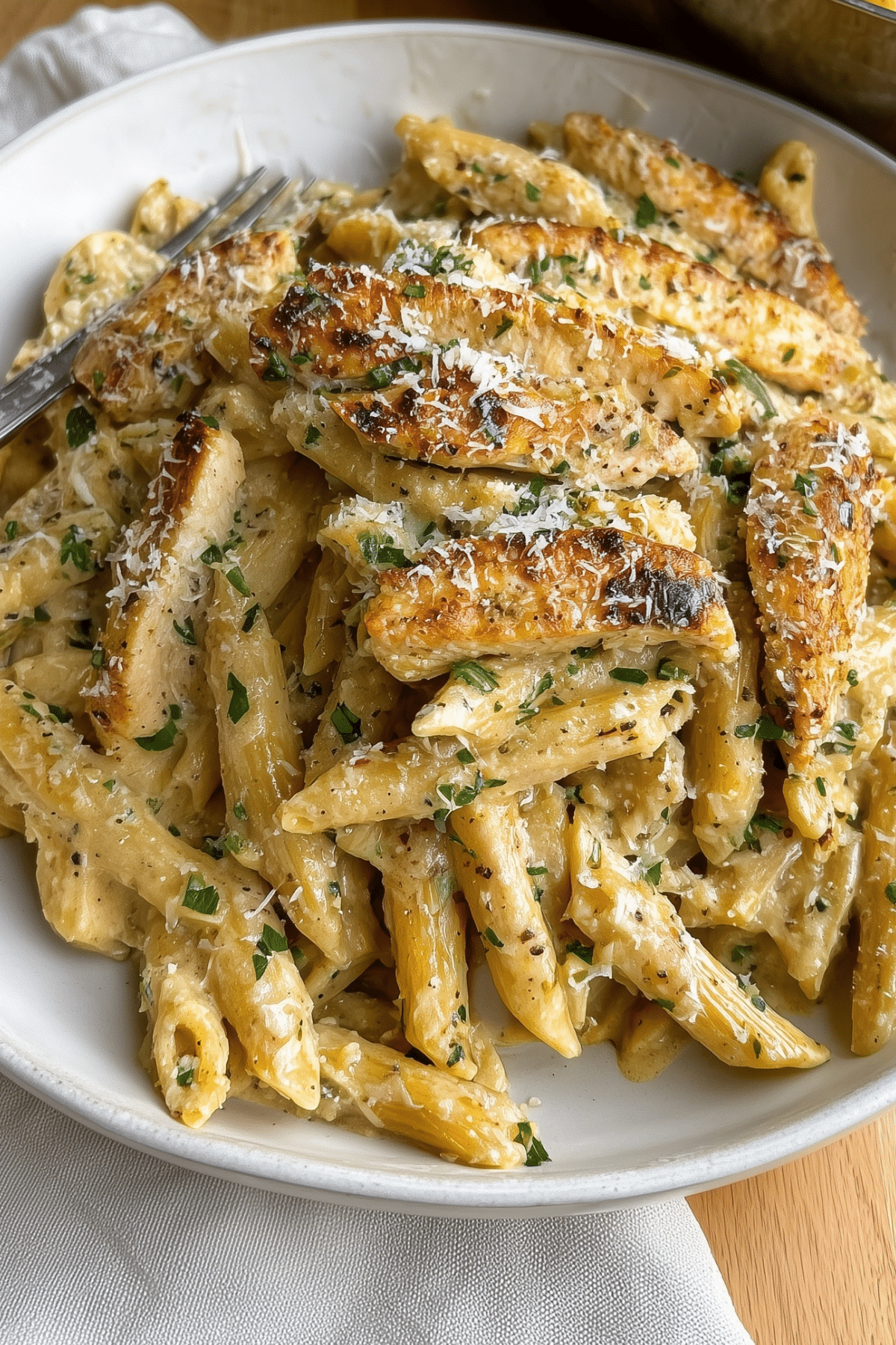 Chicken Garlic Parmesan Pasta served with creamy sauce and grilled chicken