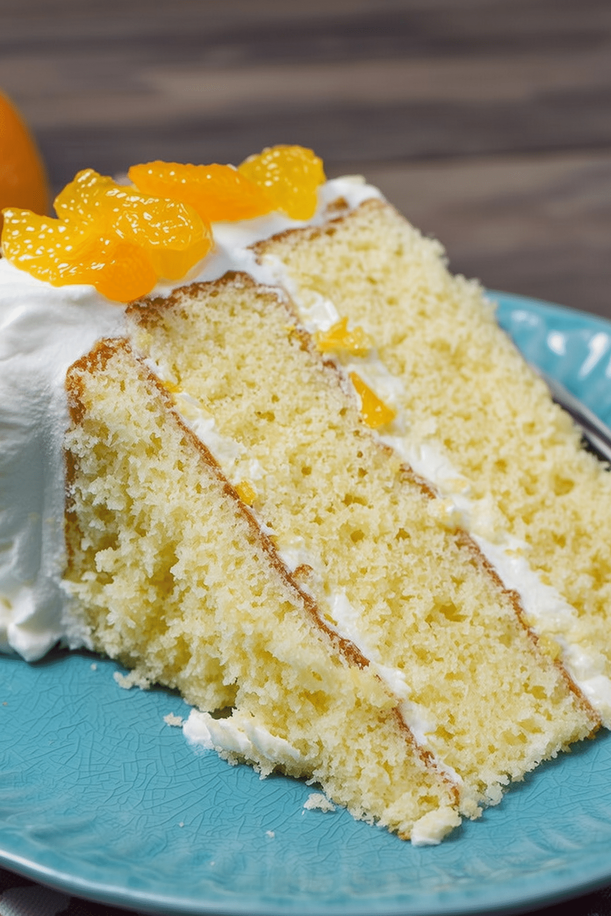 Mandarin Orange Cake with citrus frosting and fresh garnishes
