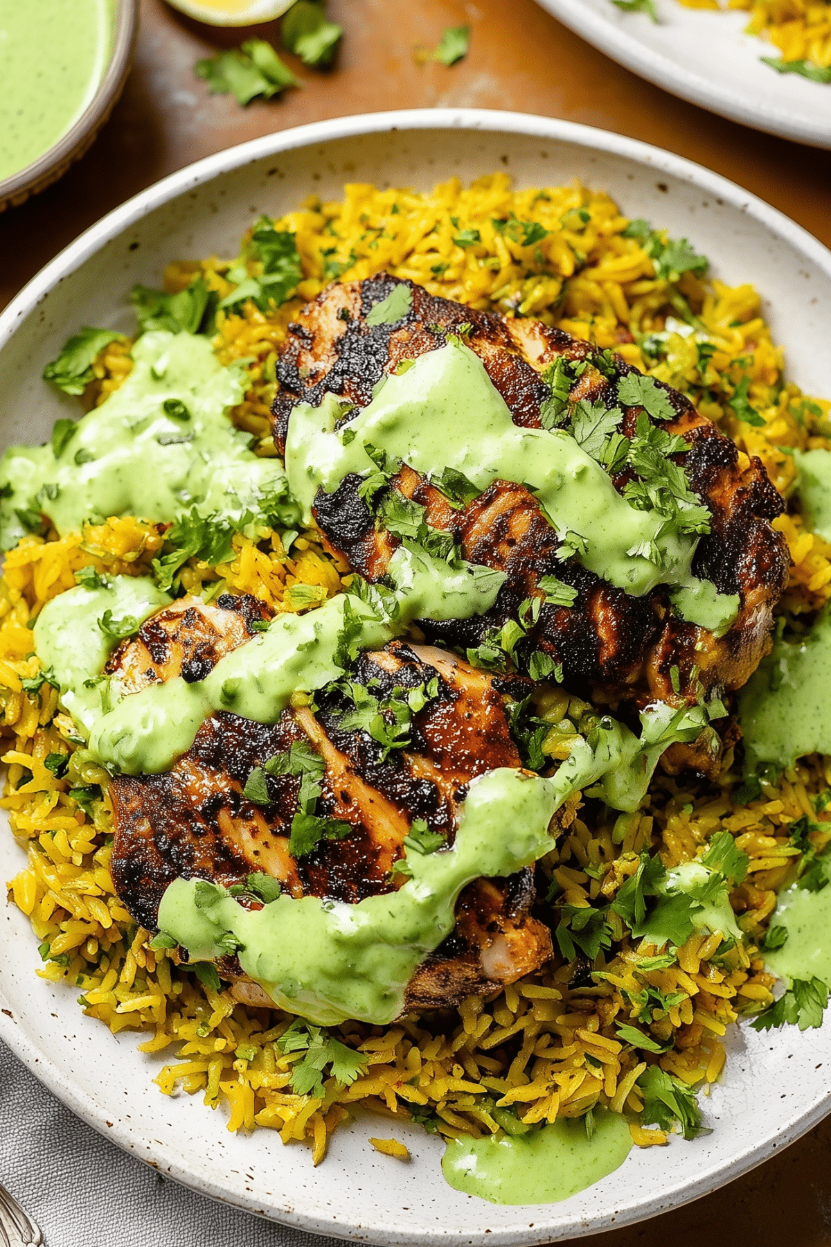 Peruvian Chicken & Rice with Green Sauce served with creamy cilantro sauce
