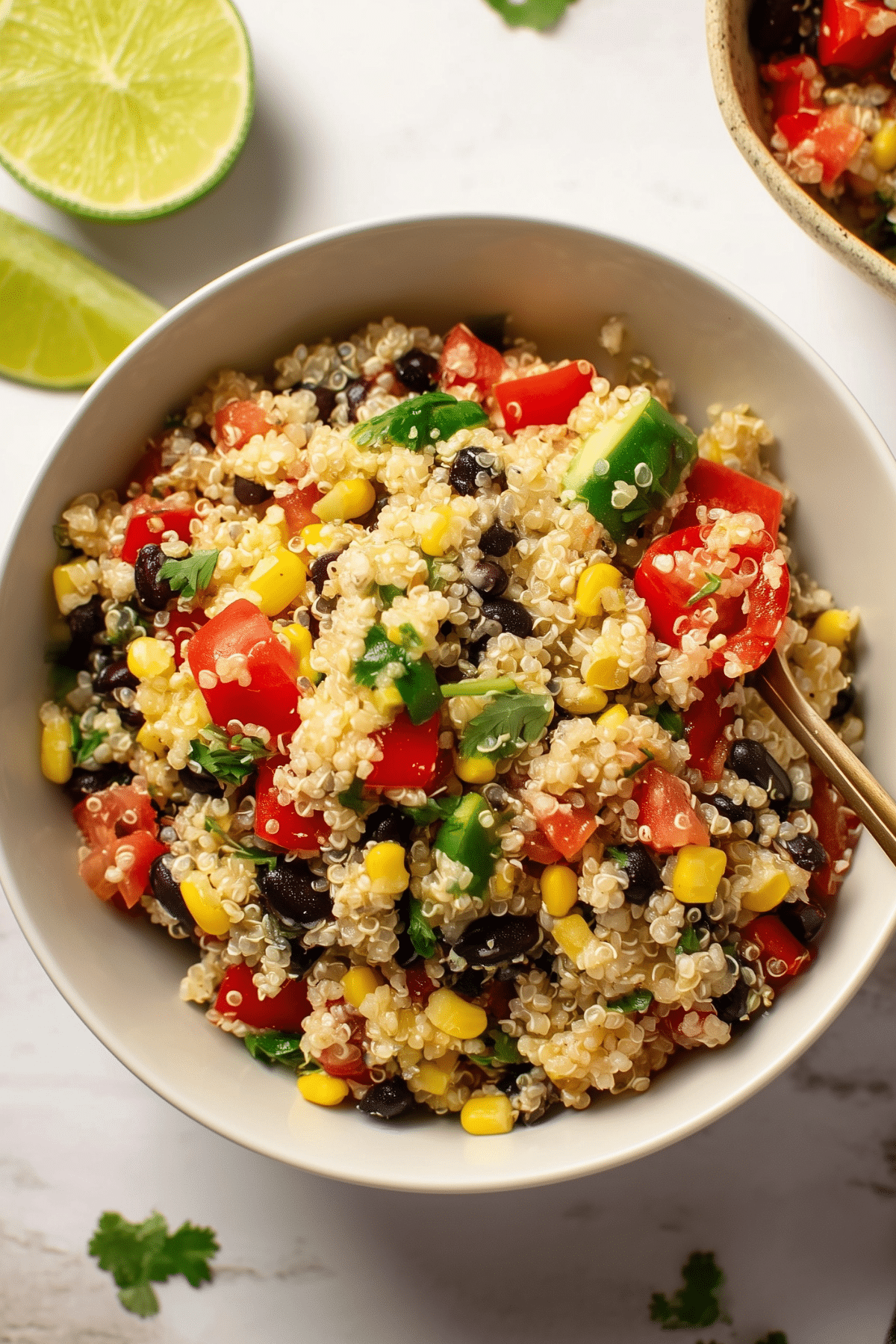 Quinoa salad with black beans, cucumber, tomatoes, and cilantro