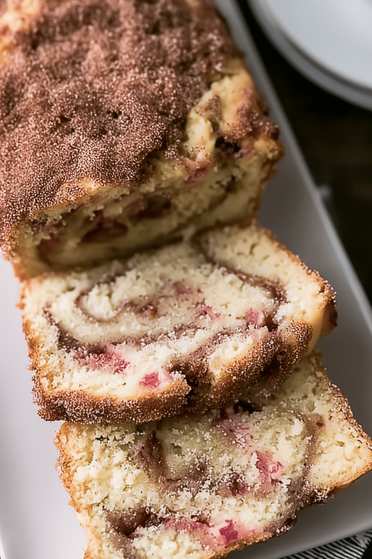rhubarb bread loaf with glaze and fresh rhubarb