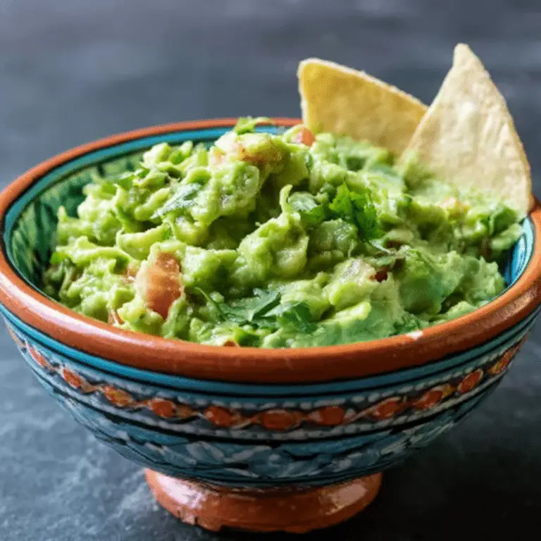 Fresh homemade Guacamole with ripe avocados and lime