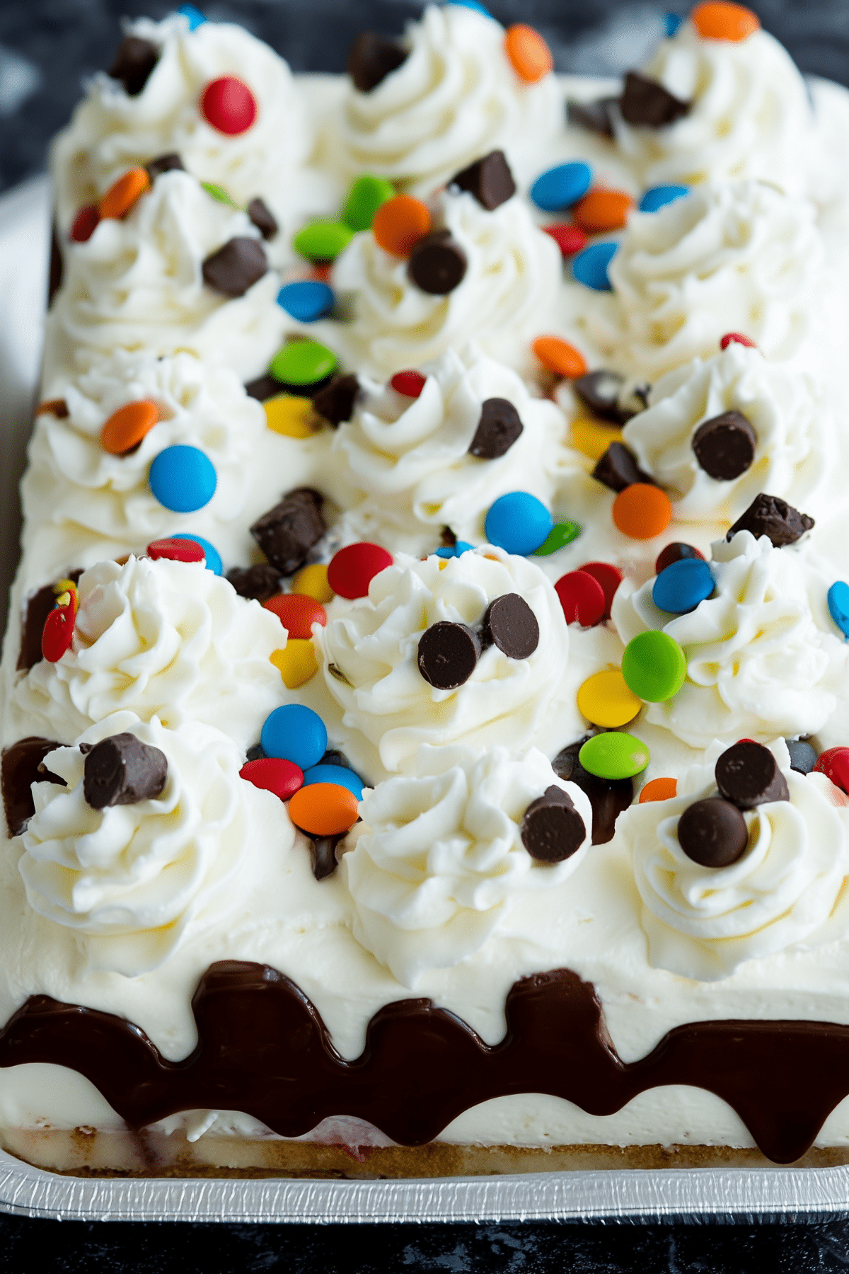 Ice Cream Sandwich Cake layered with whipped topping and candy